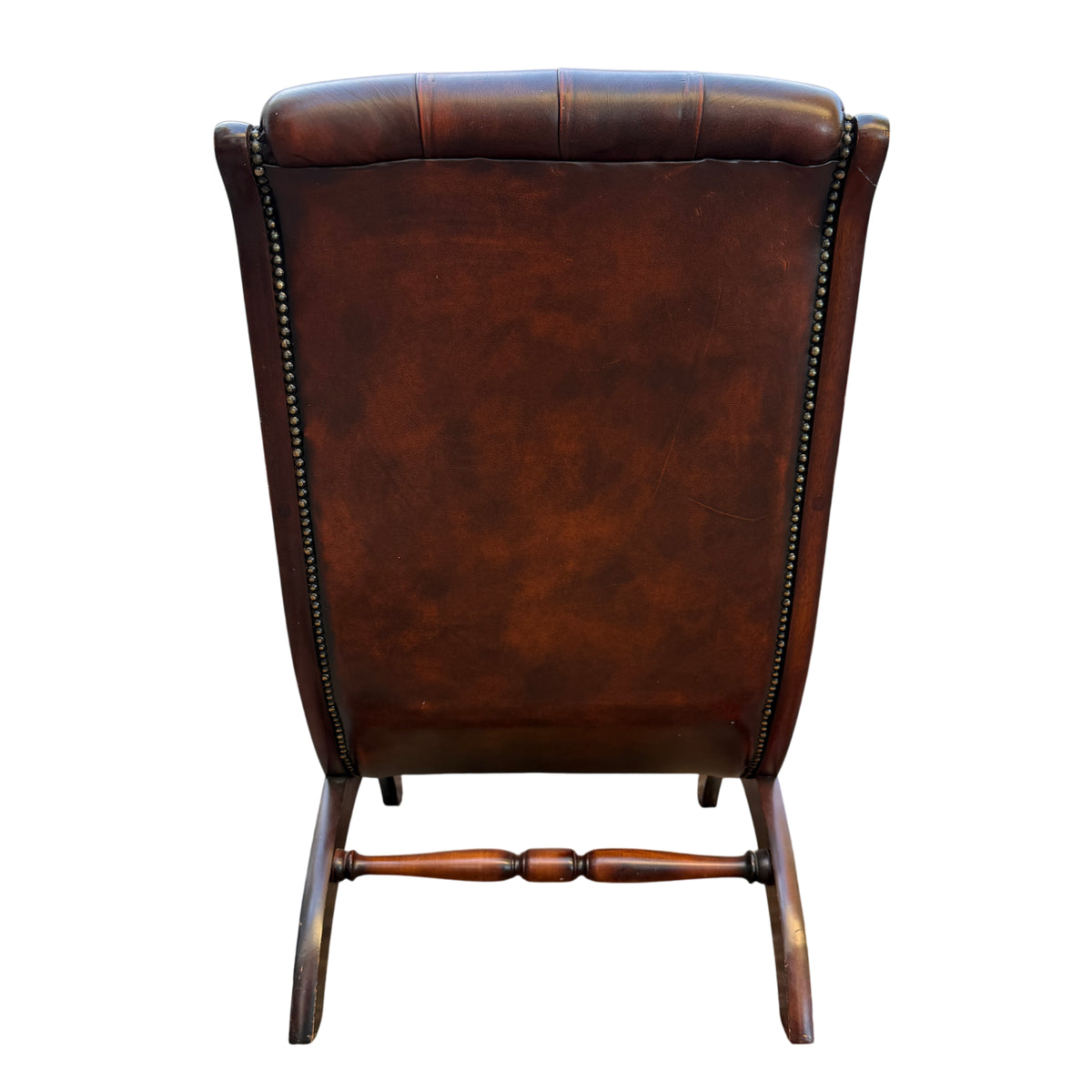 Base and leg detail of mahogany frame on Chesterfield-style slipper chair