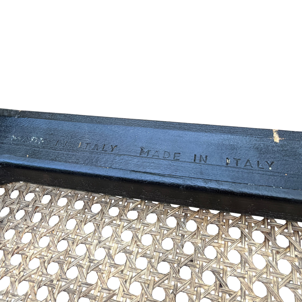Close-up of cane weaving and timber edging showing wear and areas of finish loss on the surround