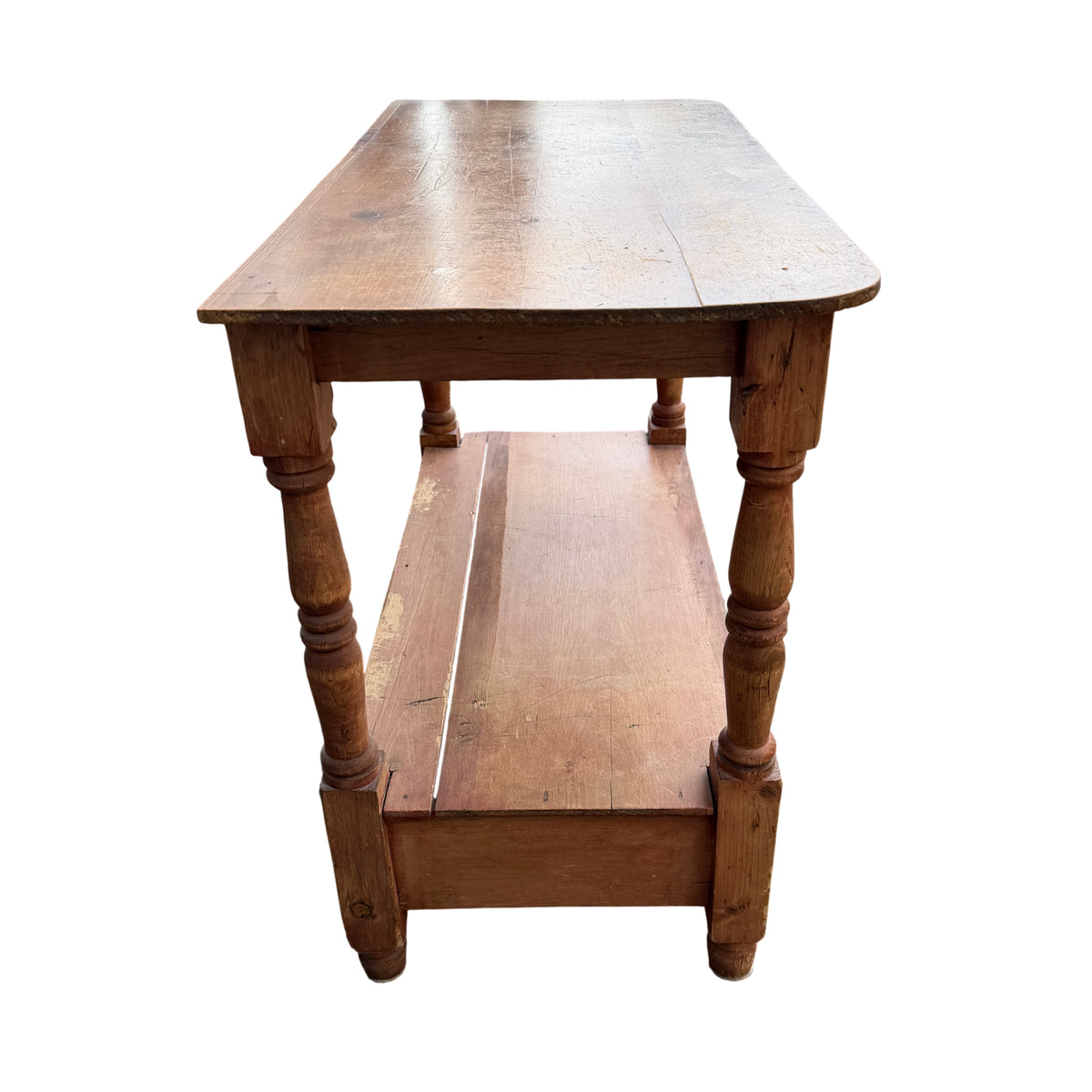 Underside view of lower shelf and leg joinery on vintage pine table