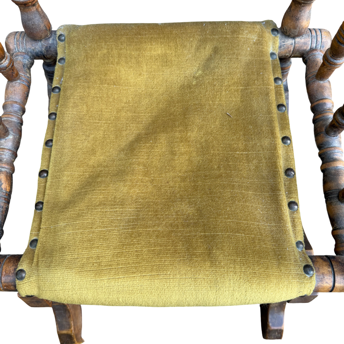 Mustard-green upholstered child’s rocker secured by round metal tacks