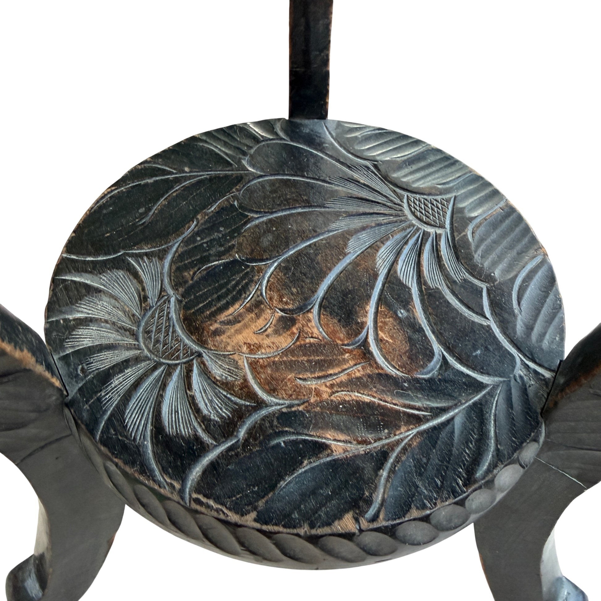 Edge detail showing carved rope border on a small wooden side table