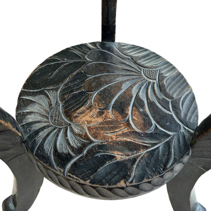 Edge detail showing carved rope border on a small wooden side table
