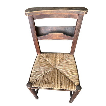 Close-up of woven rush seat on vintage wooden dining chair