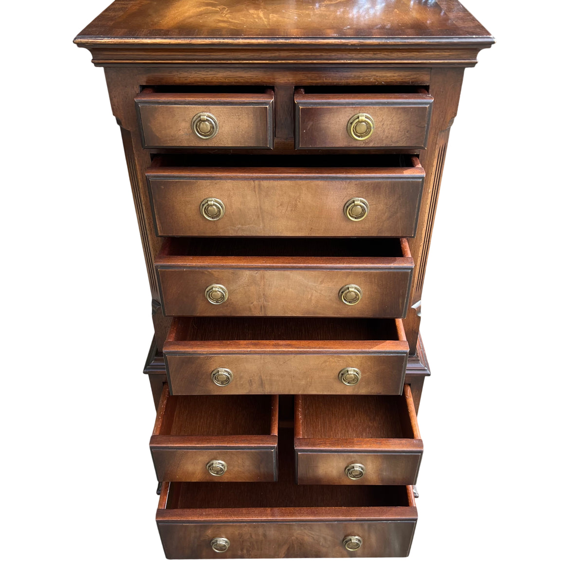 Detail of brass ring drawer pulls on a vintage mahogany chest of drawers