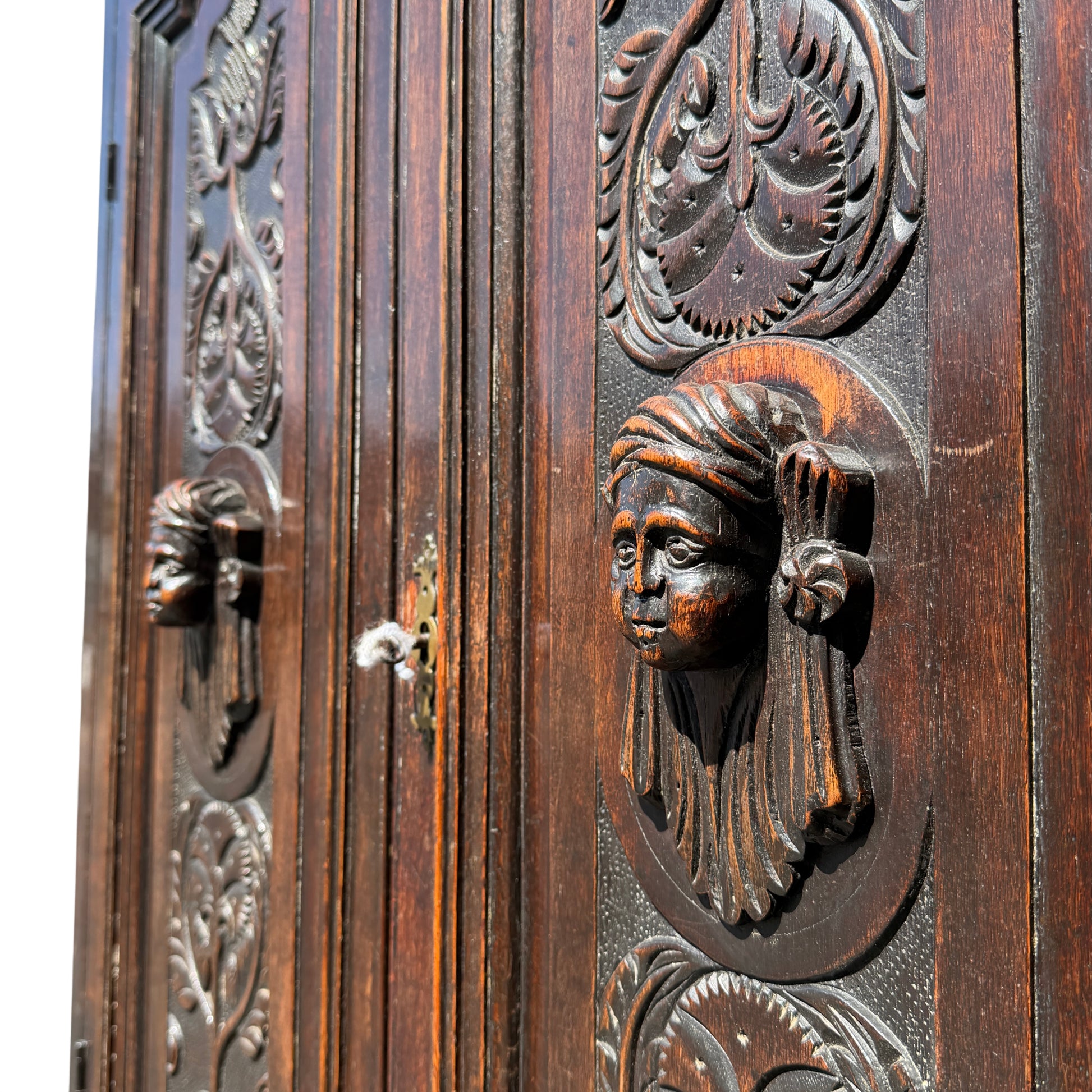 Lower drawers with carved oak fronts and brass drop handles