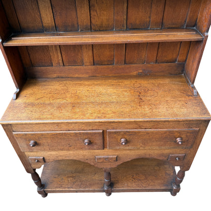 Lower section of oak dresser with turned supports and bun feet