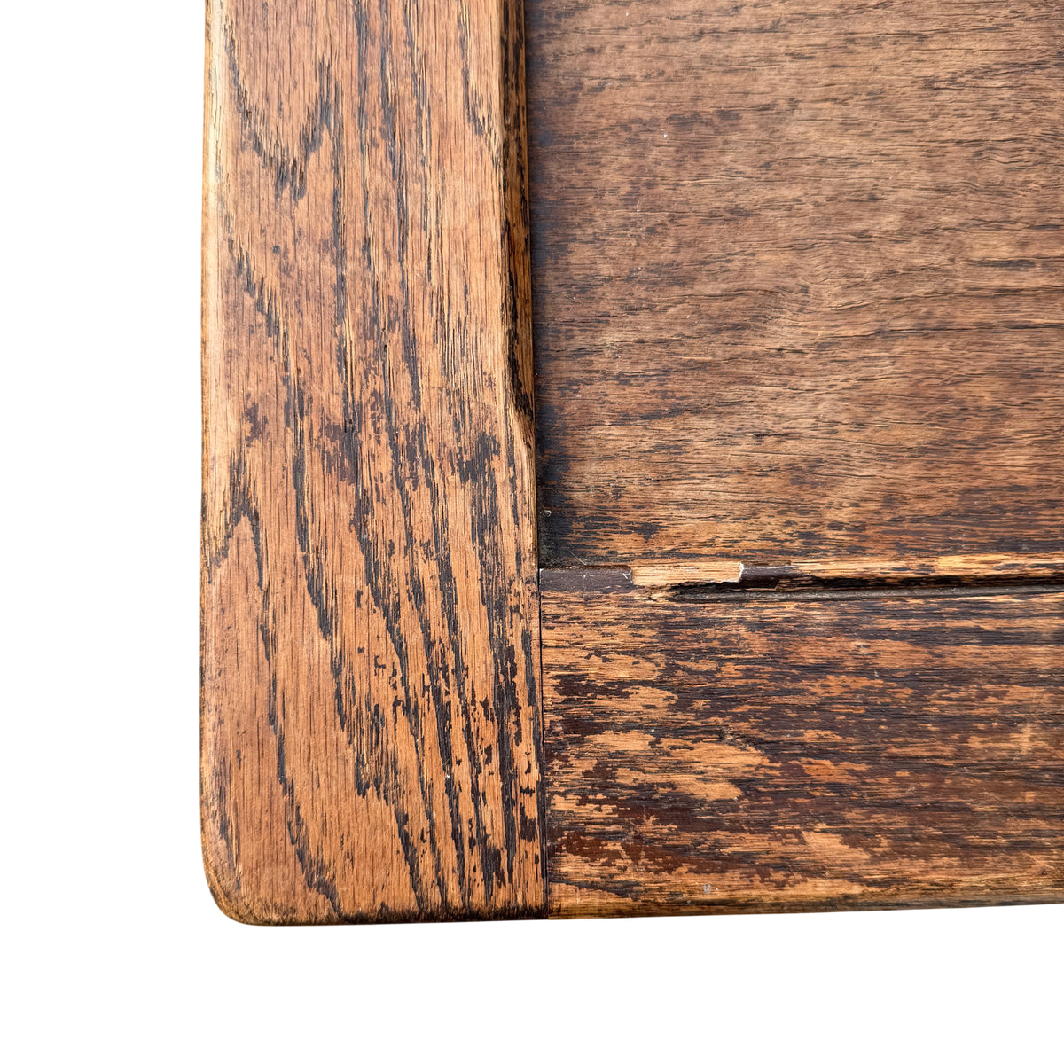 Lower front of oak coffer showing carved diamond panel and moulded base