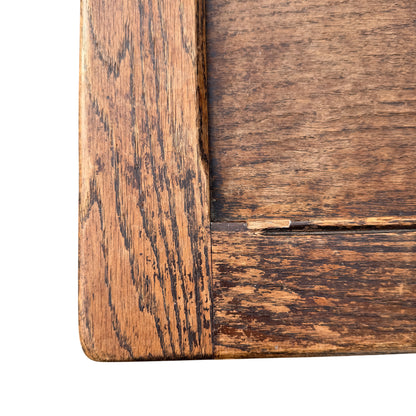 Lower front of oak coffer showing carved diamond panel and moulded base