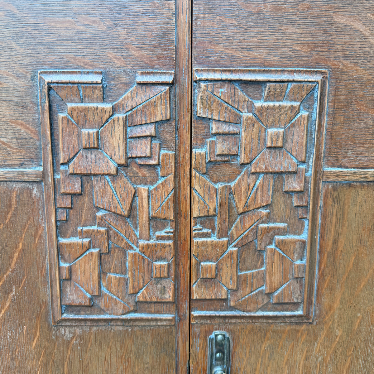 Close up of iron pull and key escutcheon on Art Deco linen press