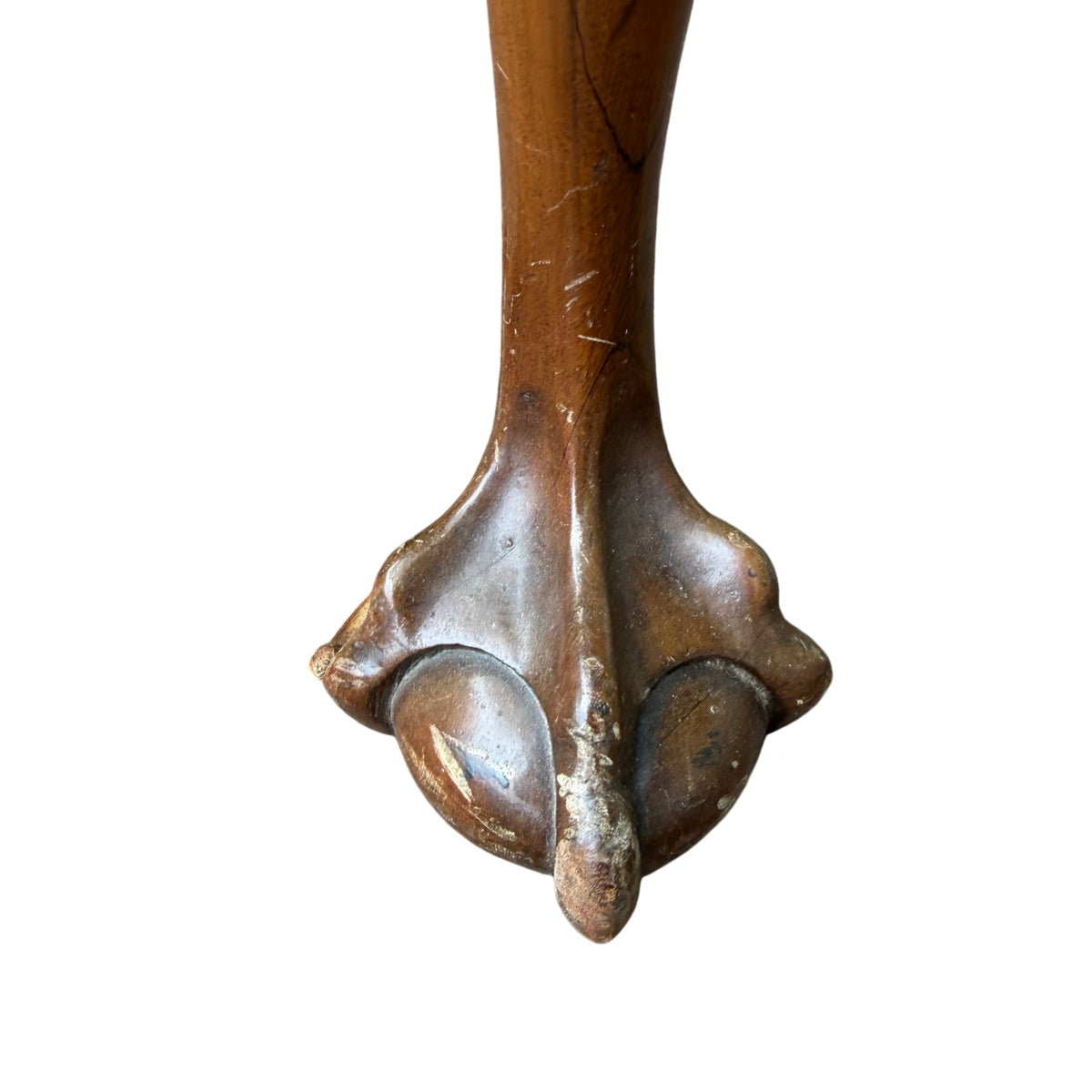 Carved ball and claw foot on a vintage reproduction walnut coffee table