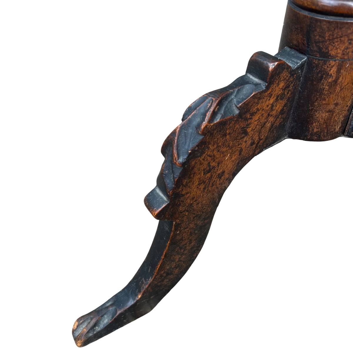 Lower view of carved splayed tripod legs on a Victorian walnut pedestal table
