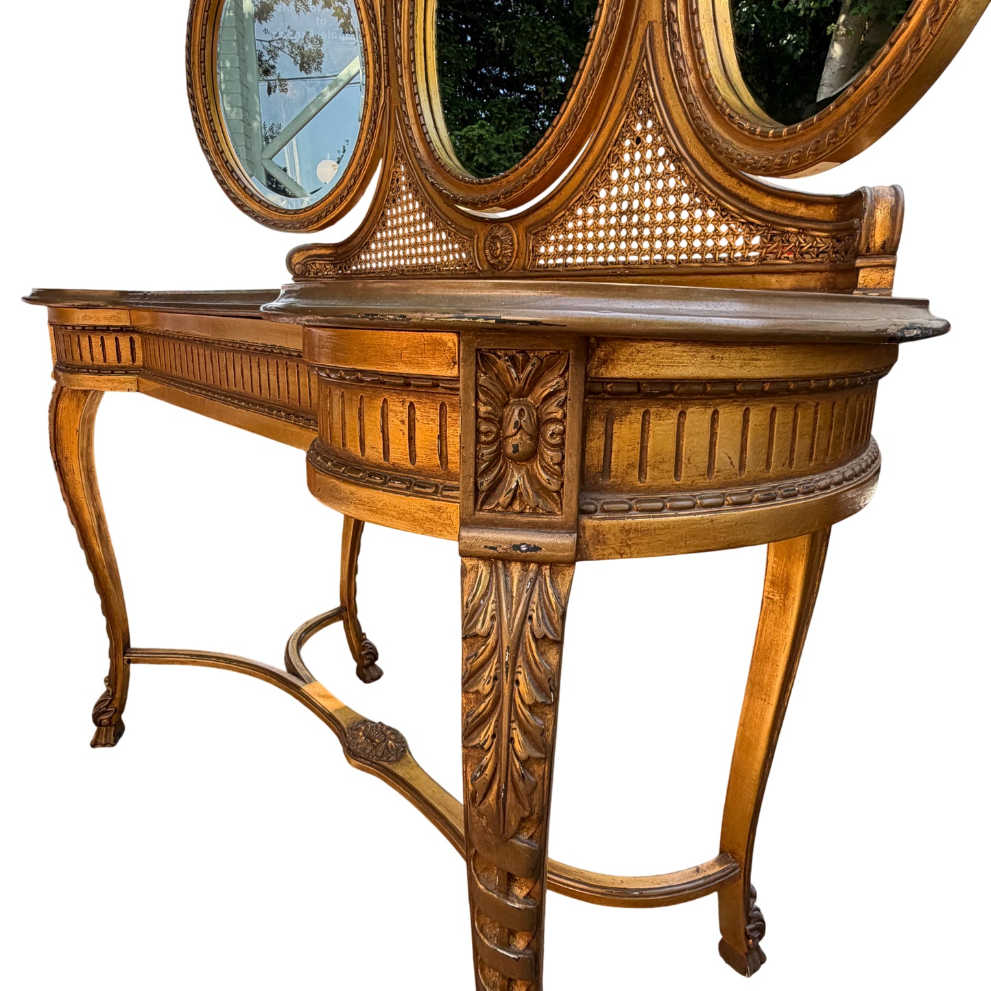 Detail of carved gilt crest and three mirrors on dressing table