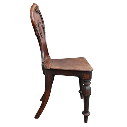 Detail of turned leg with paint and finish wear on antique chair