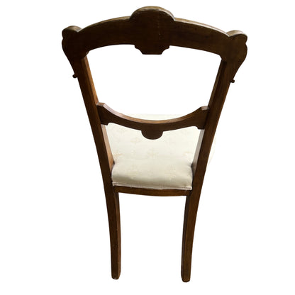 Cream damask upholstered seat on a Victorian oak dining chair