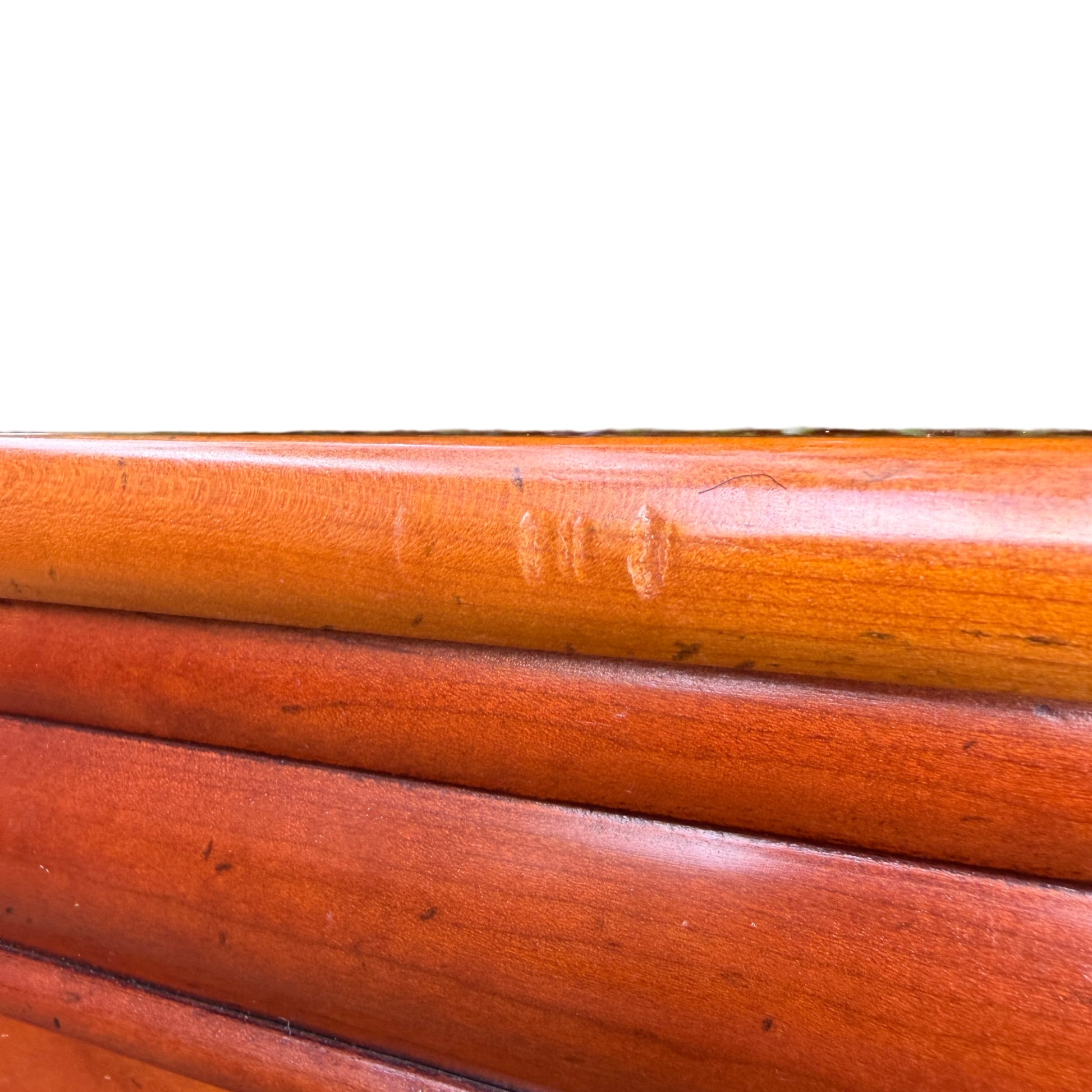Top view of the cupboard showing smooth warm wood surface and rounded edge