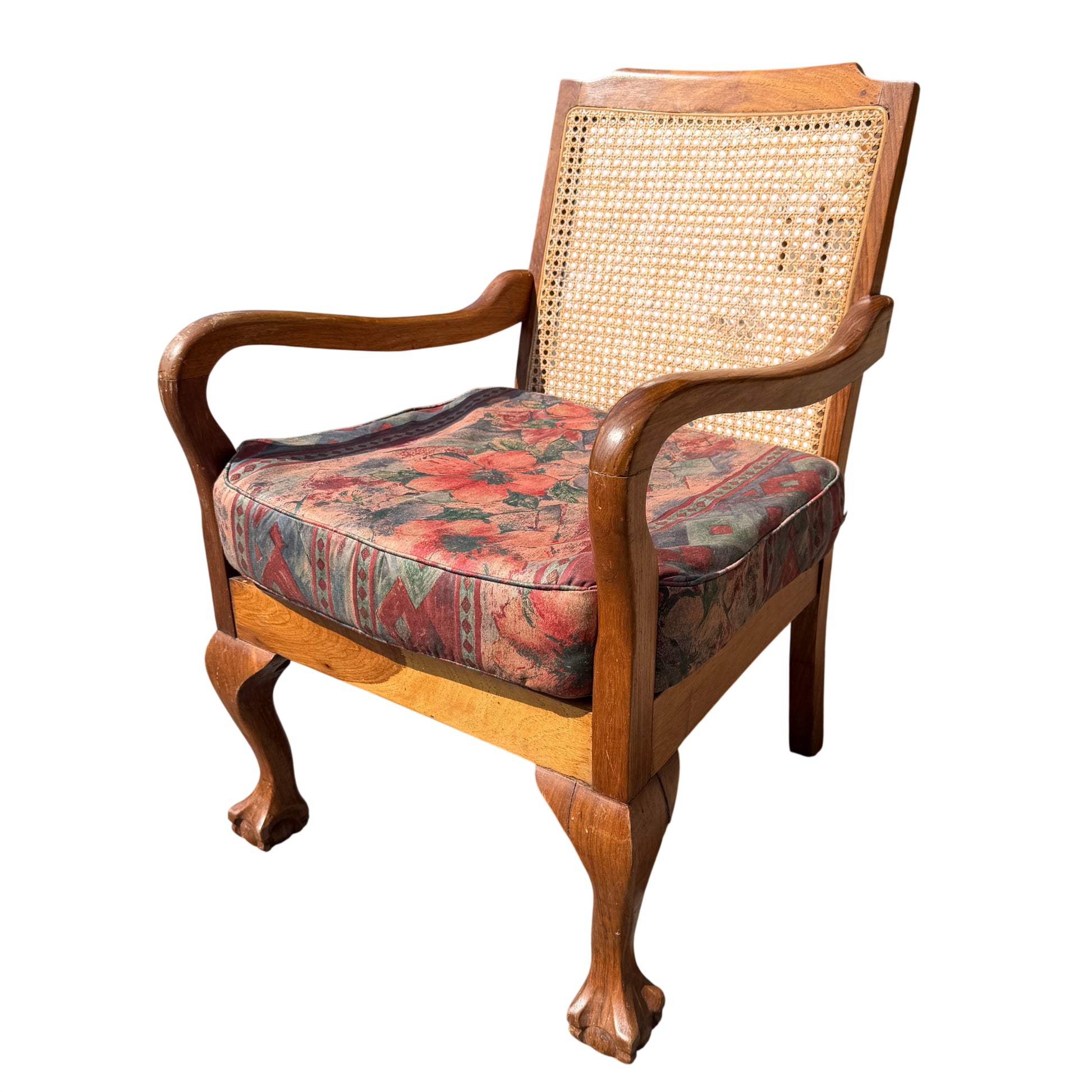 Vintage caned armchair with wooden frame and patterned upholstered seat