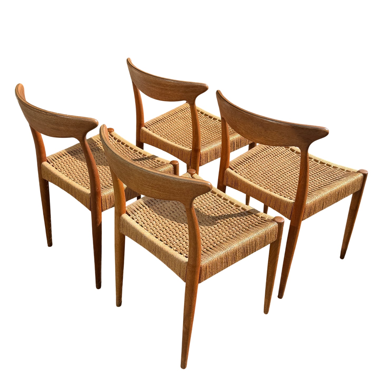 Woven seat detail and front legs of a vintage Danish dining chair