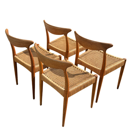 Woven seat detail and front legs of a vintage Danish dining chair