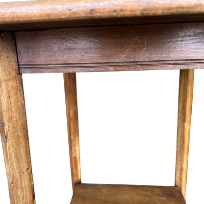 Full front view of vintage oak hall table with two lower shelves and slim legs