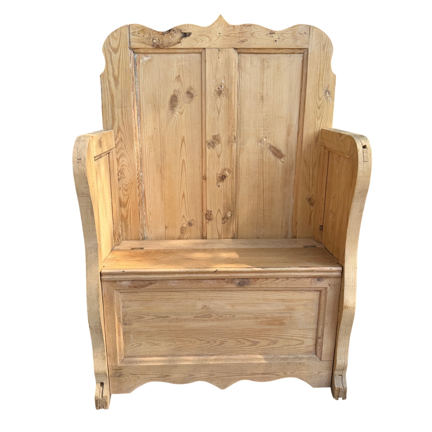 High-backed pine settle with lift-up seat and visible knotty grain
