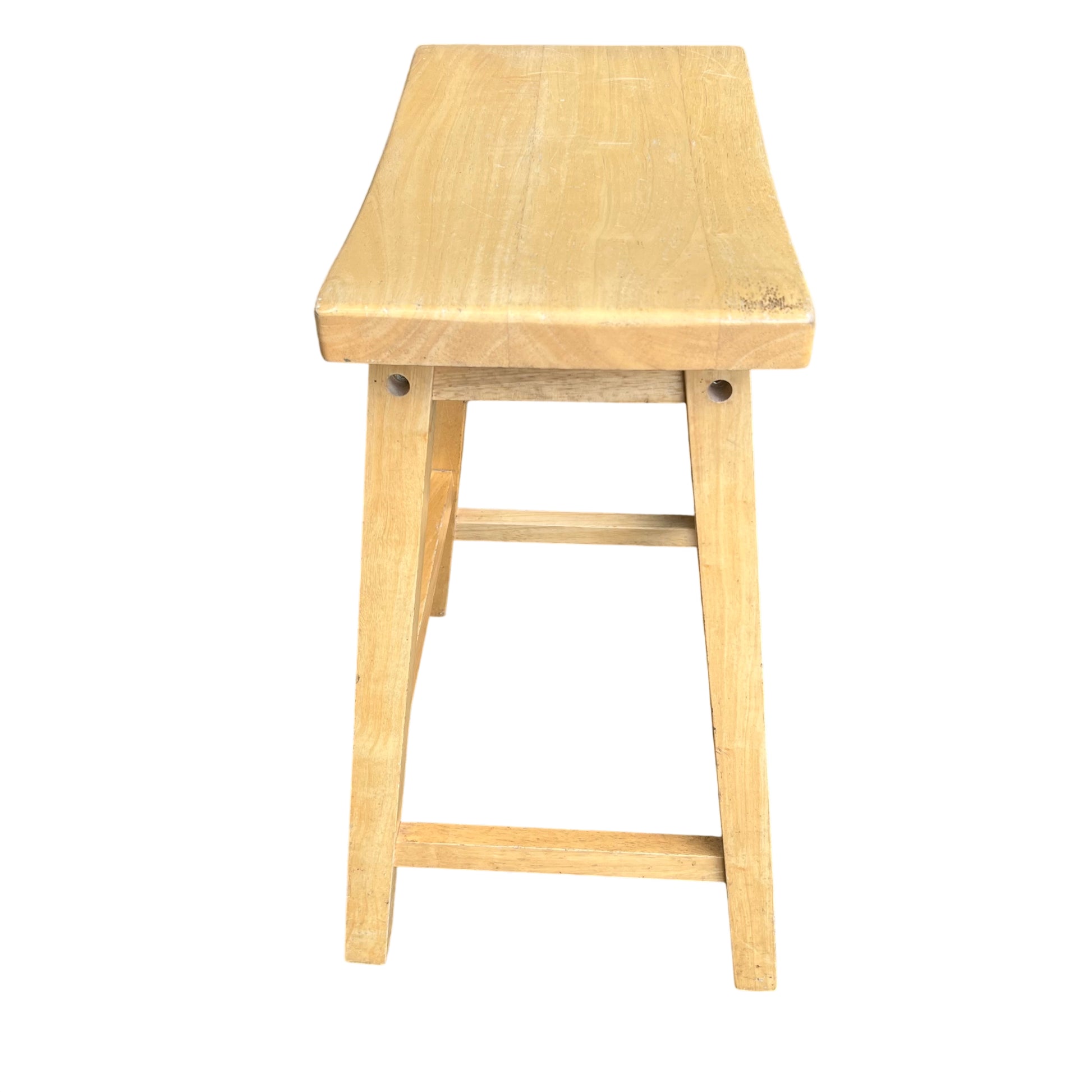 Detail of the curved seat edge and light wood grain on stool