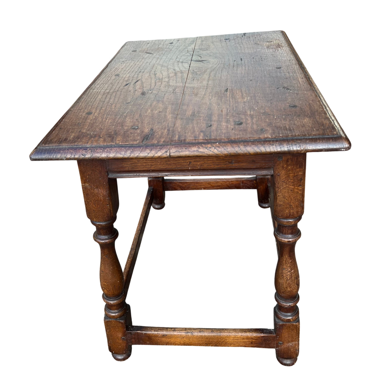 Rectangular oak lamp table showing plank top grain and nail plugs