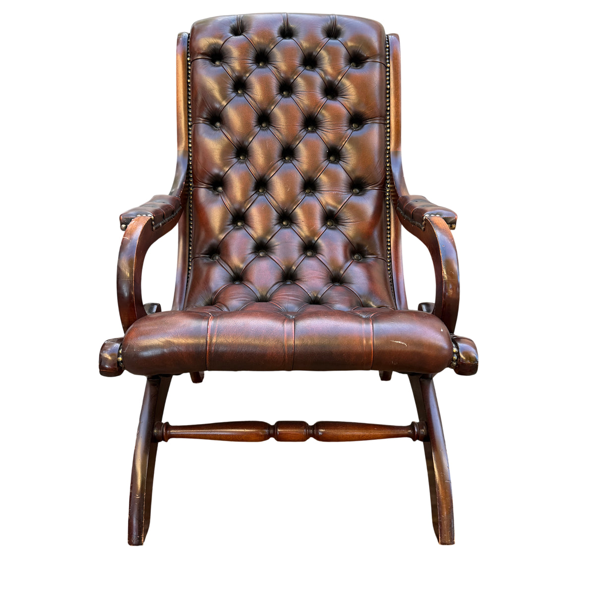 Campeche-style library armchair with curved mahogany frame and stud detailing