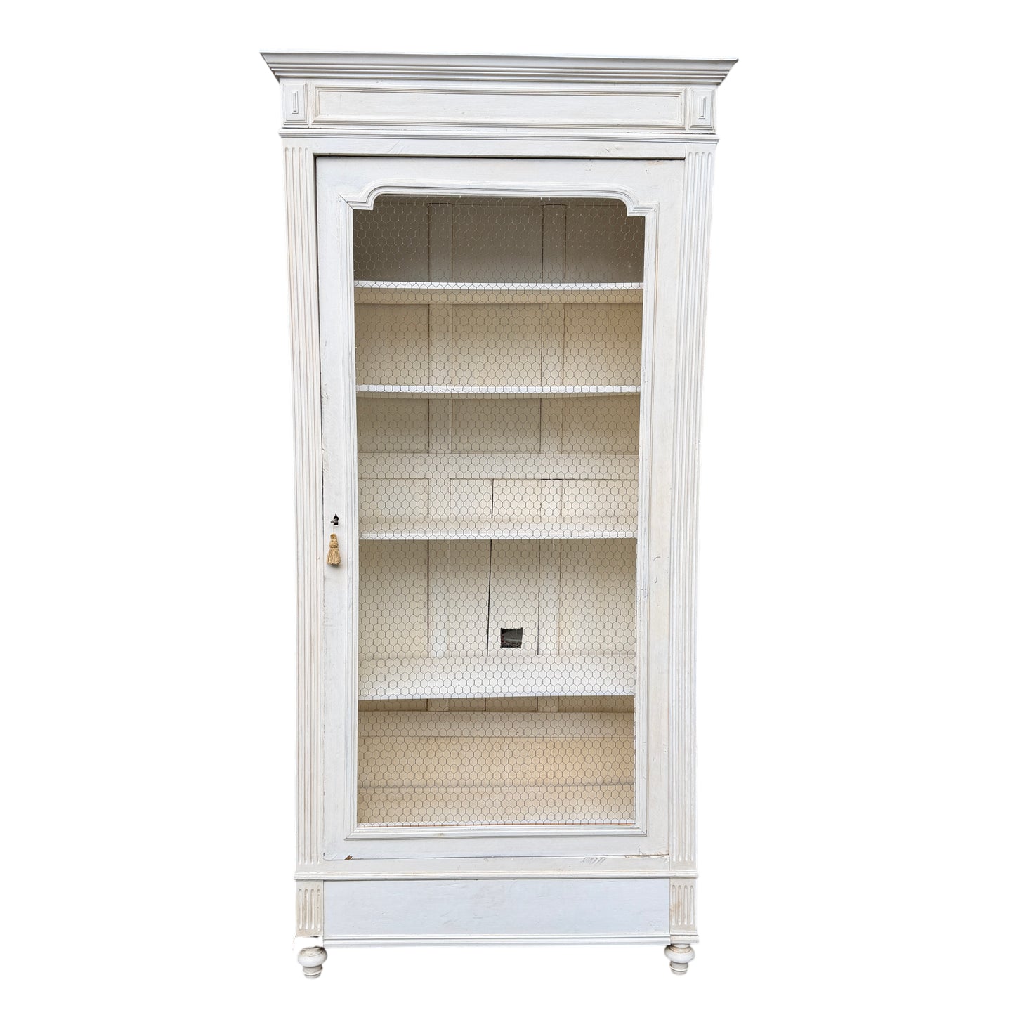 Front view of vintage French painted display cabinet with wire mesh door and interior shelves