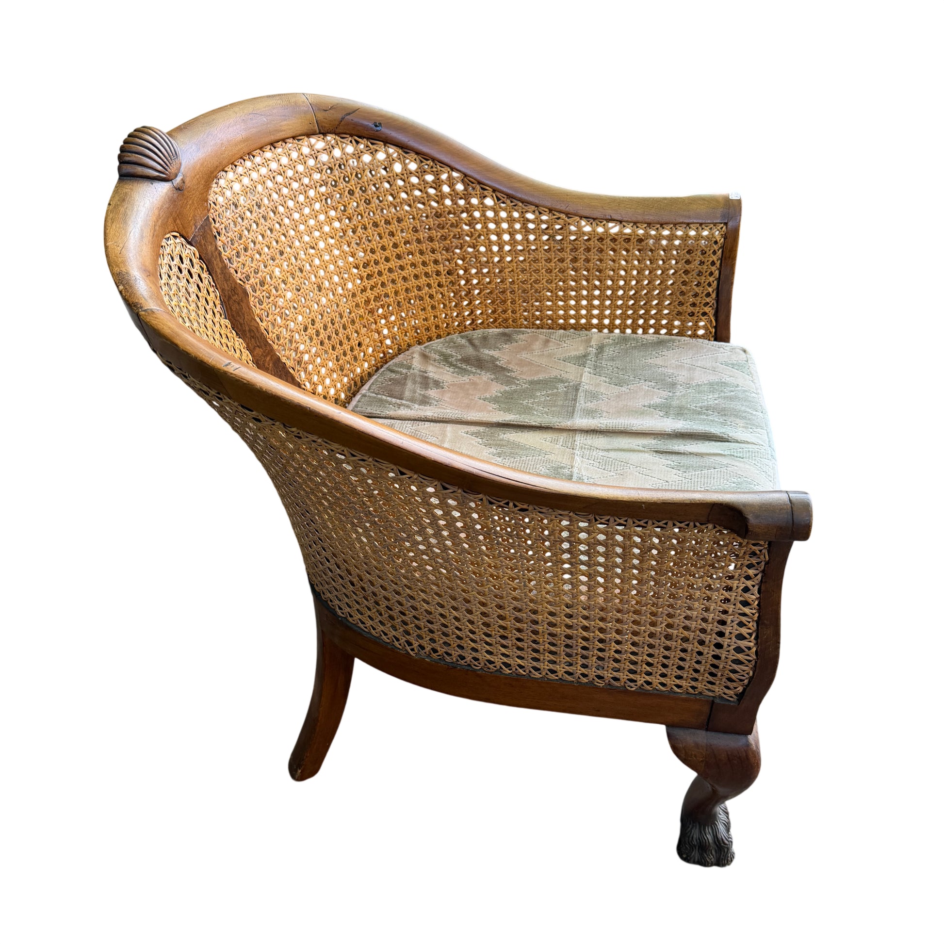 Front view of vintage armchair with loose upholstered seat cushion and cane sides