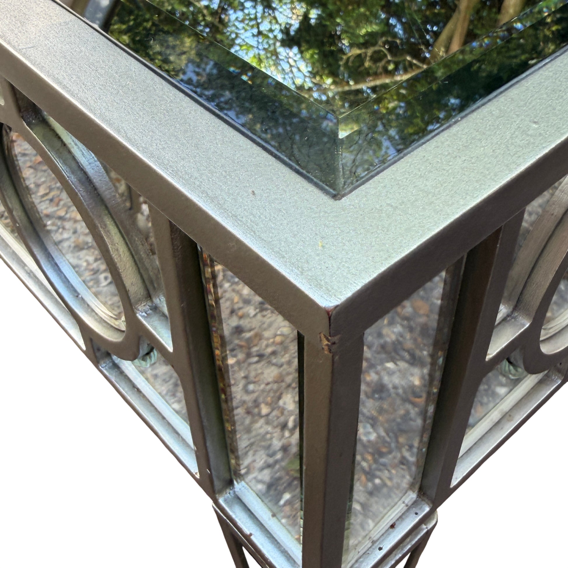 Detail of mirrored table leg with silver finish and ball foot
