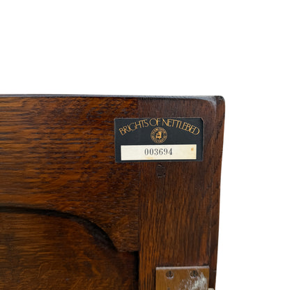 Turned front leg detail on vintage oak cabinet with plain rear legs