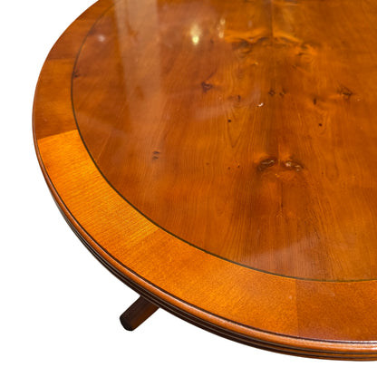 Close up of oval table top showing wood grain and banded edge in mahogany finish
