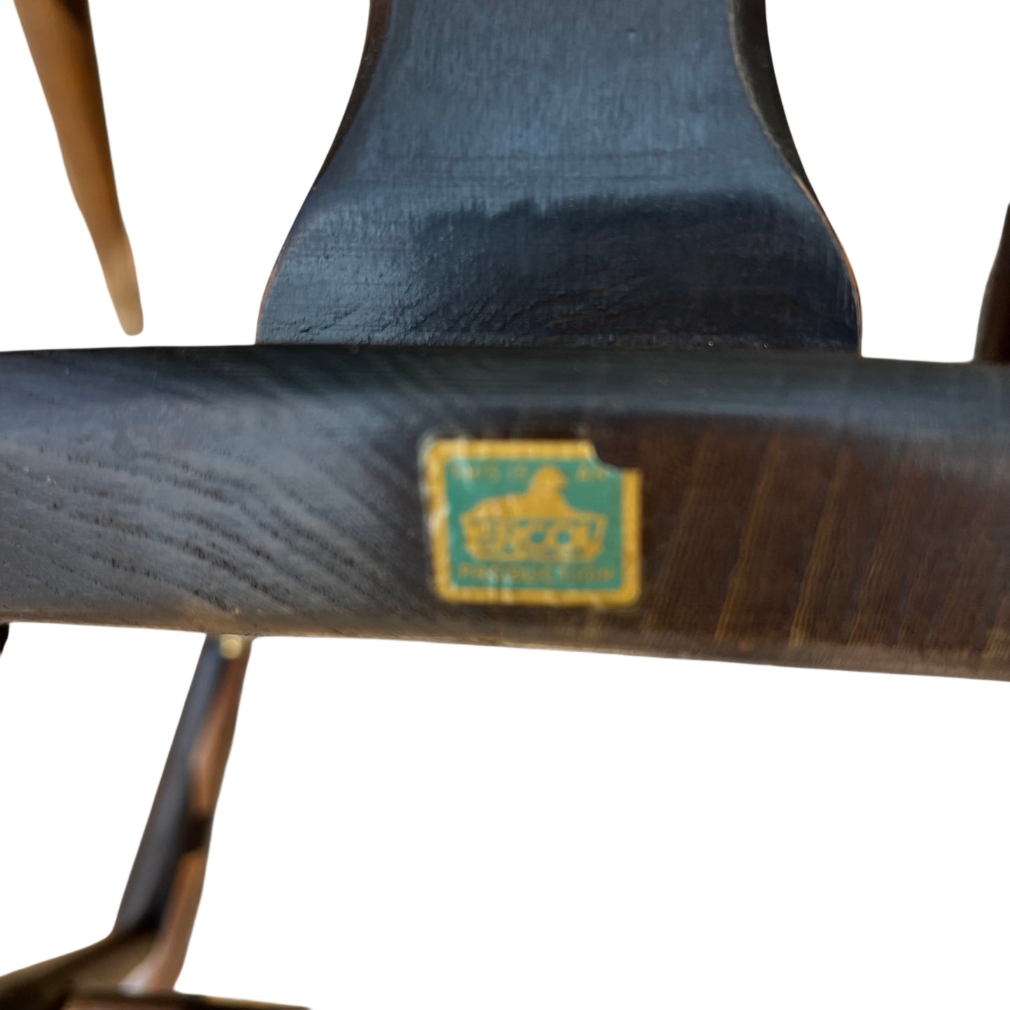 Front view of vintage dining chair with shaped wooden seat and swept legs