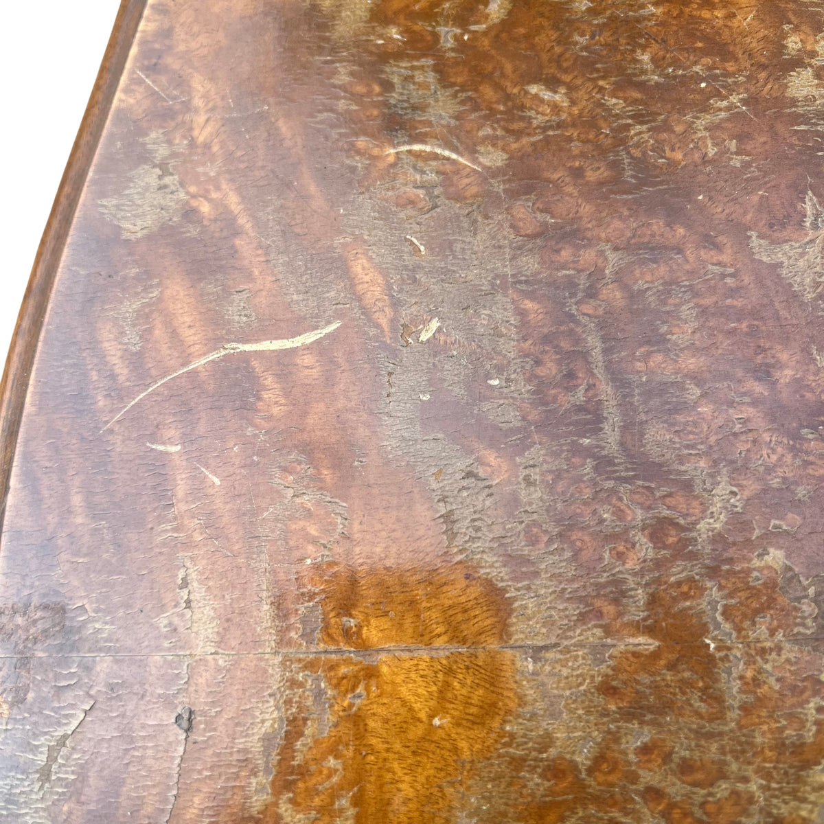 Shaped base and bracket feet of vintage walnut chest of drawers