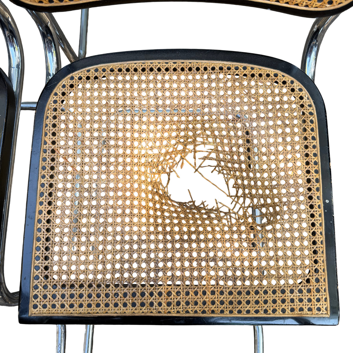 Chrome tubular cantilever frame and under-seat structure of a vintage Arrben dining chair