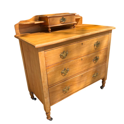 Vintage pine chest of drawers with raised gallery top, turned legs and brass handles