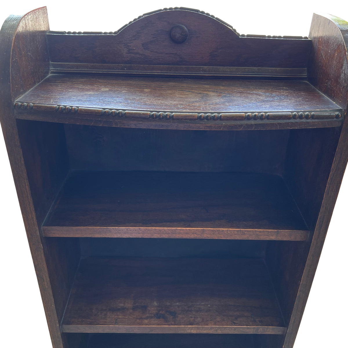 Lower shelves and base of narrow oak bookcase showing solid shelf construction
