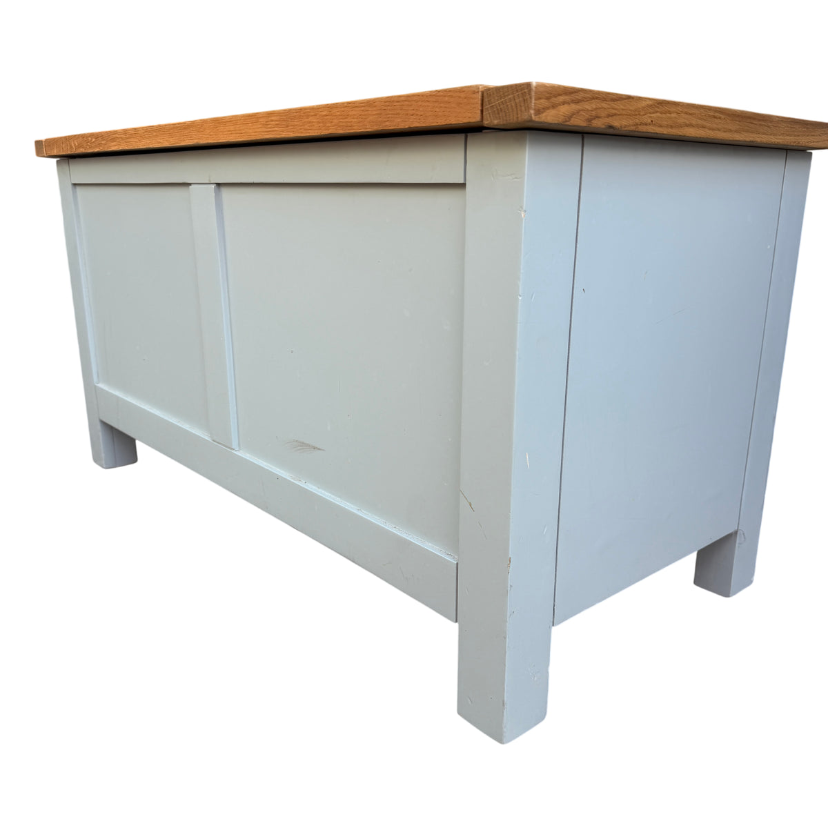Close-up of oak top and painted shelf supported by curved side panels on hall bench