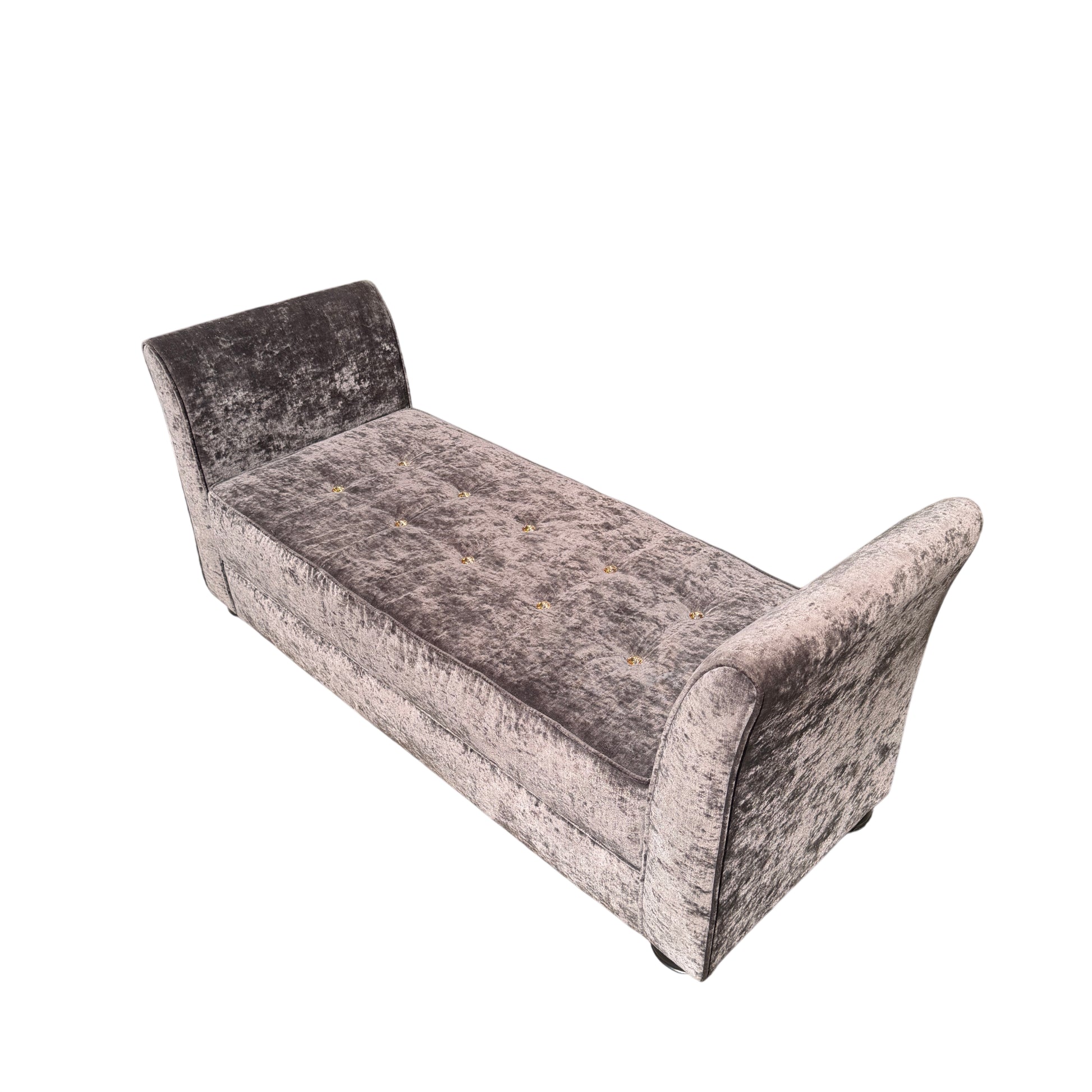 Curved arm detail on a grey upholstered chaise longue with plush velvet