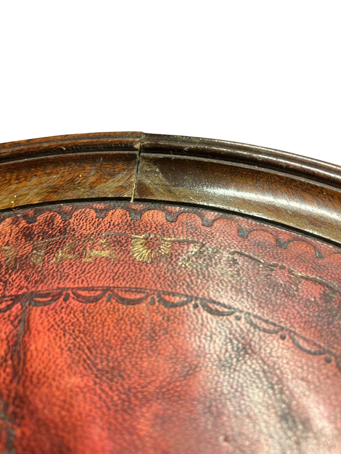 Detail of mahogany rim showing a small split at the top join on the pedestal table