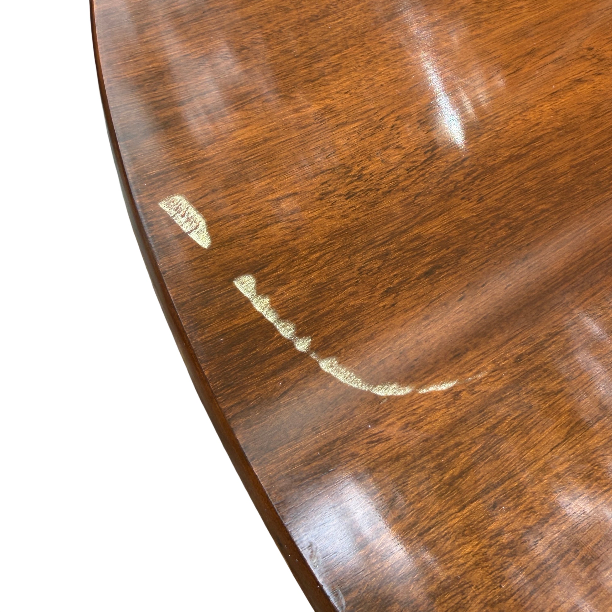 Round mahogany veneer dining table top showing warm brown finish and grain