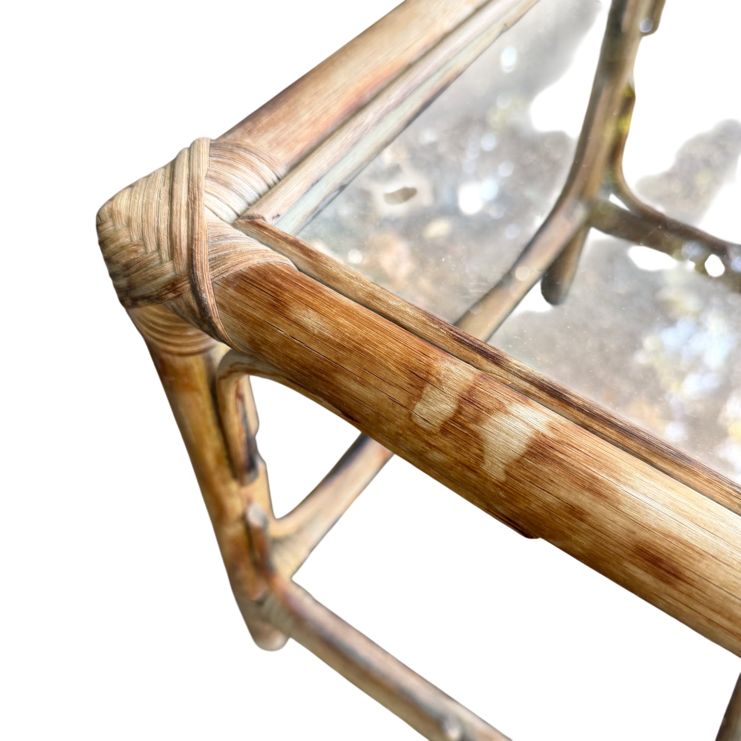 Top-down view of glass top rattan nesting tables stacked inside each other