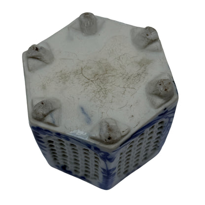Close-up of pierced lattice panels on a blue and white porcelain pot