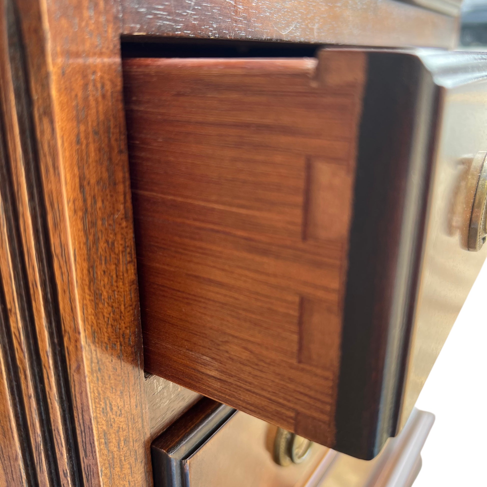 Side profile showing fluted applied detailing on the narrow chest of drawers