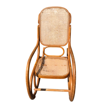 Front view of vintage bentwood rocking chair showing caned back and curved arms