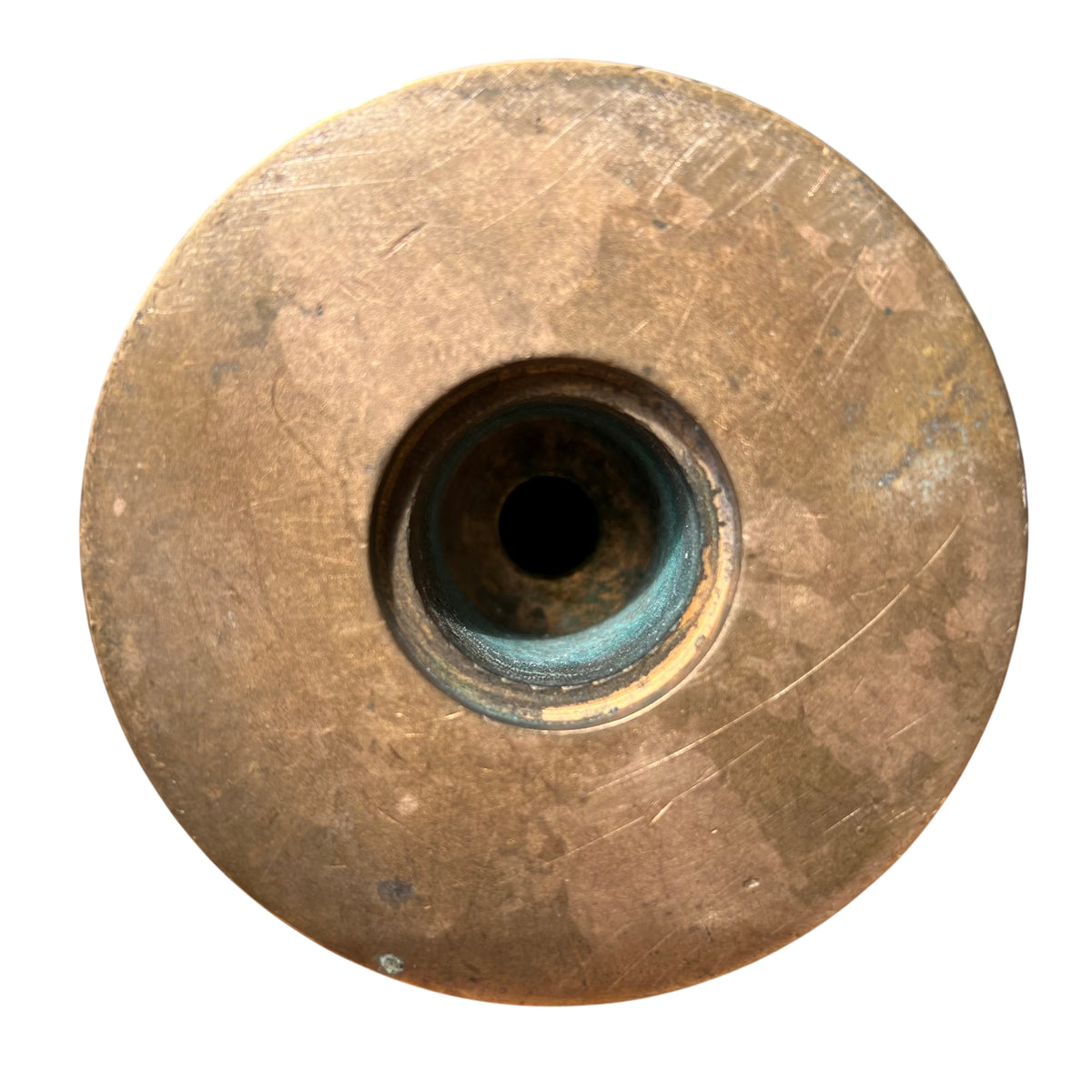 Detail of recessed grooves showing green patina on a vintage brass candlestick stem