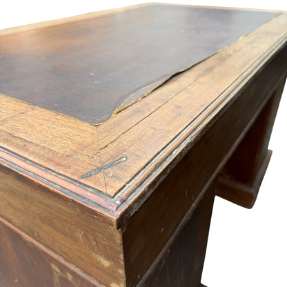 Kneehole view under pedestal desk showing central opening and drawer layout
