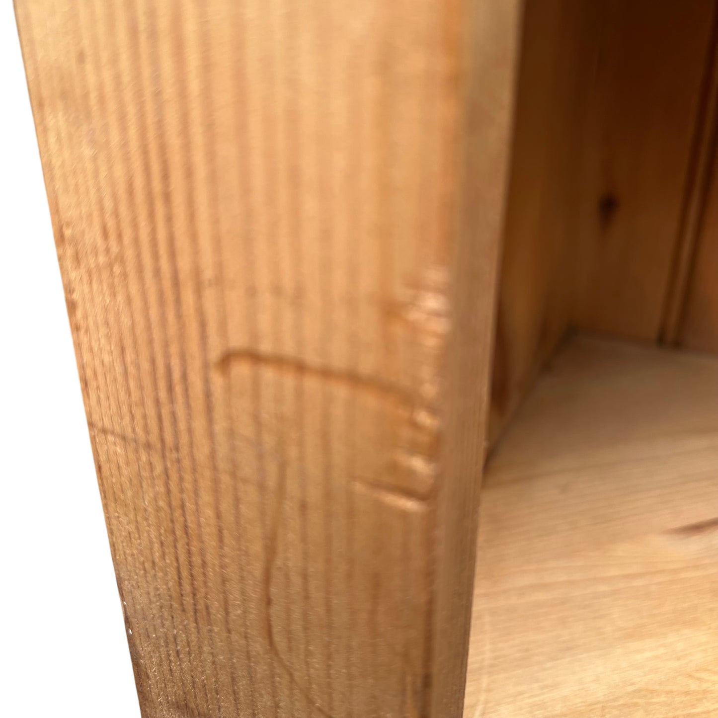 Base and feet of oak wine rack cabinet showing wear and patina