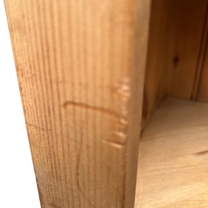 Base and feet of oak wine rack cabinet showing wear and patina