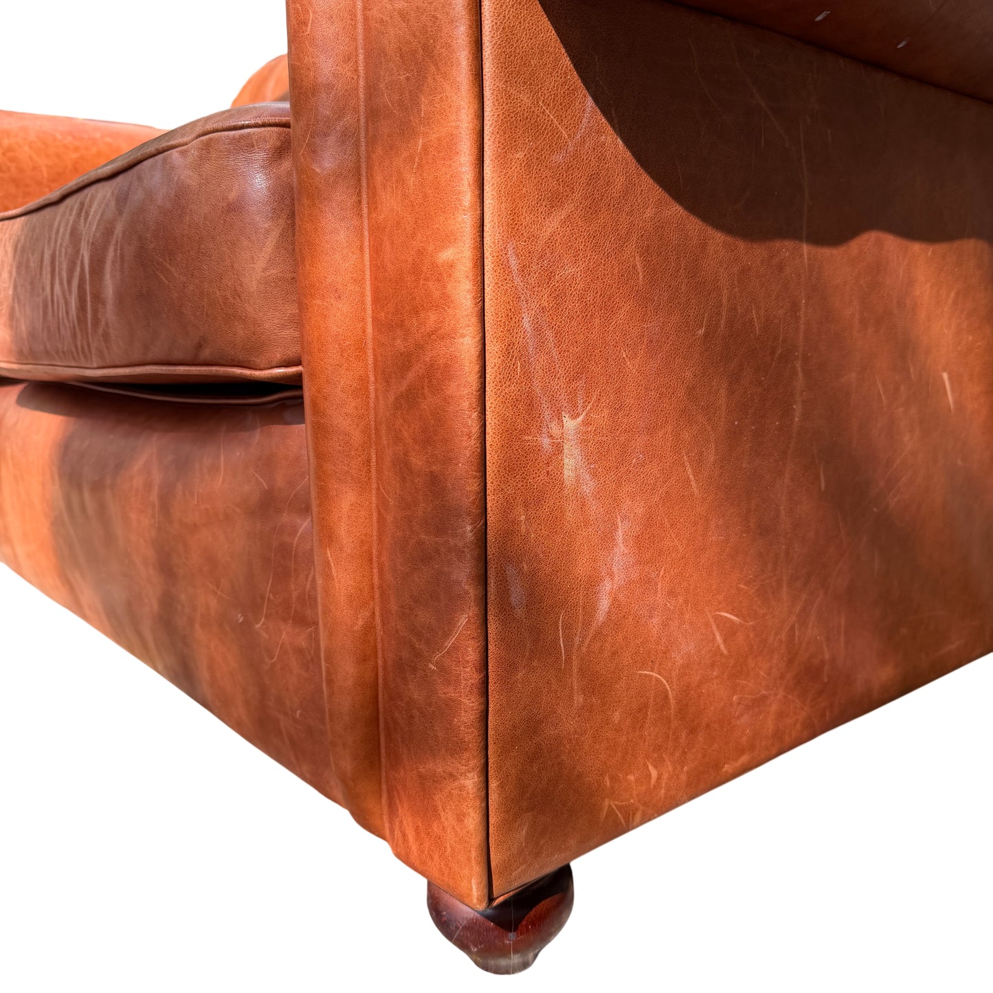 Deep seat cushions and back cushions on tan leather Wesley-Barrell two-seater sofa